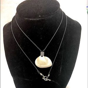 Seashell pendant with black waxed chord, silver clasp.